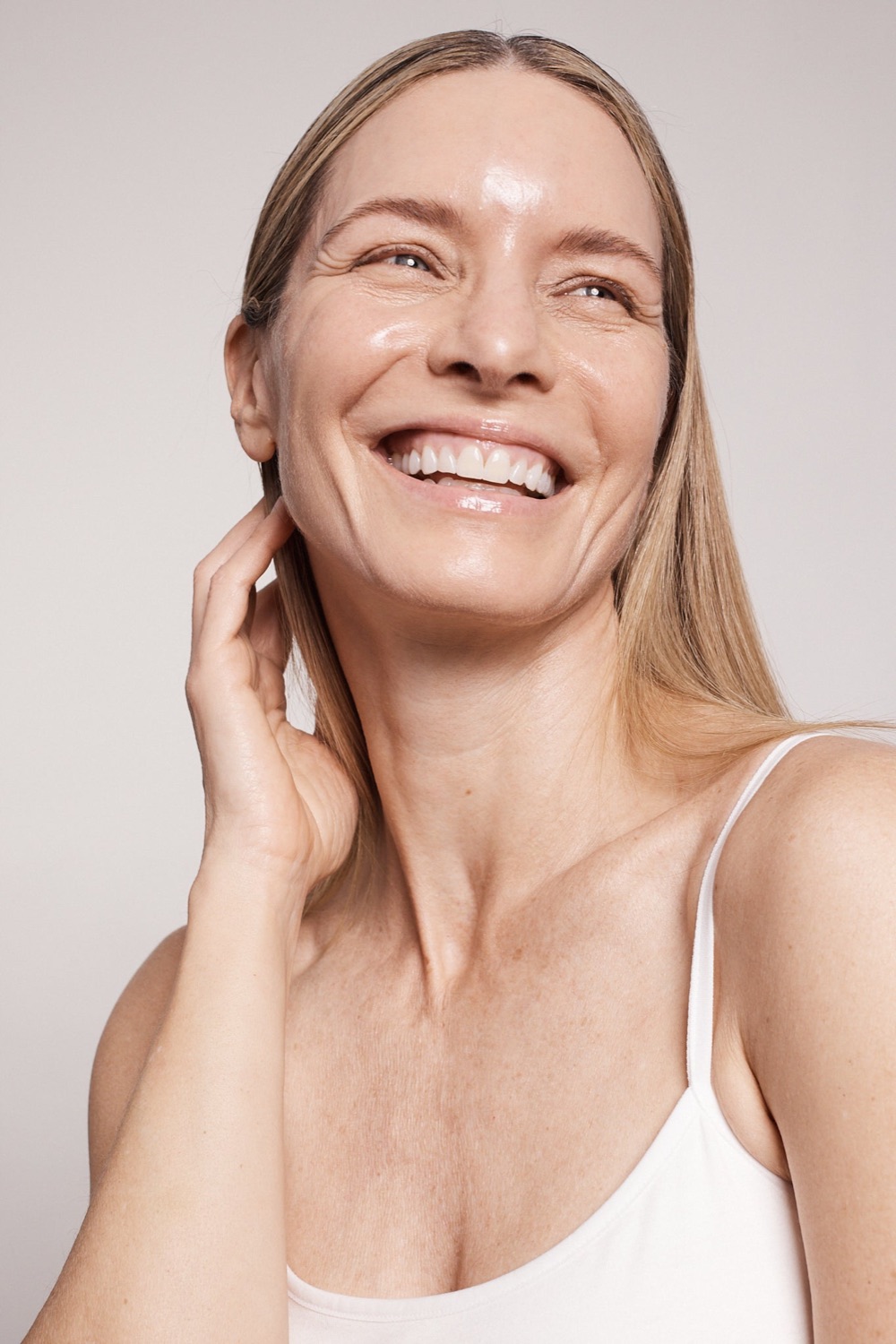 A woman with radiant, glowing skin after a Hydrafacial treatment